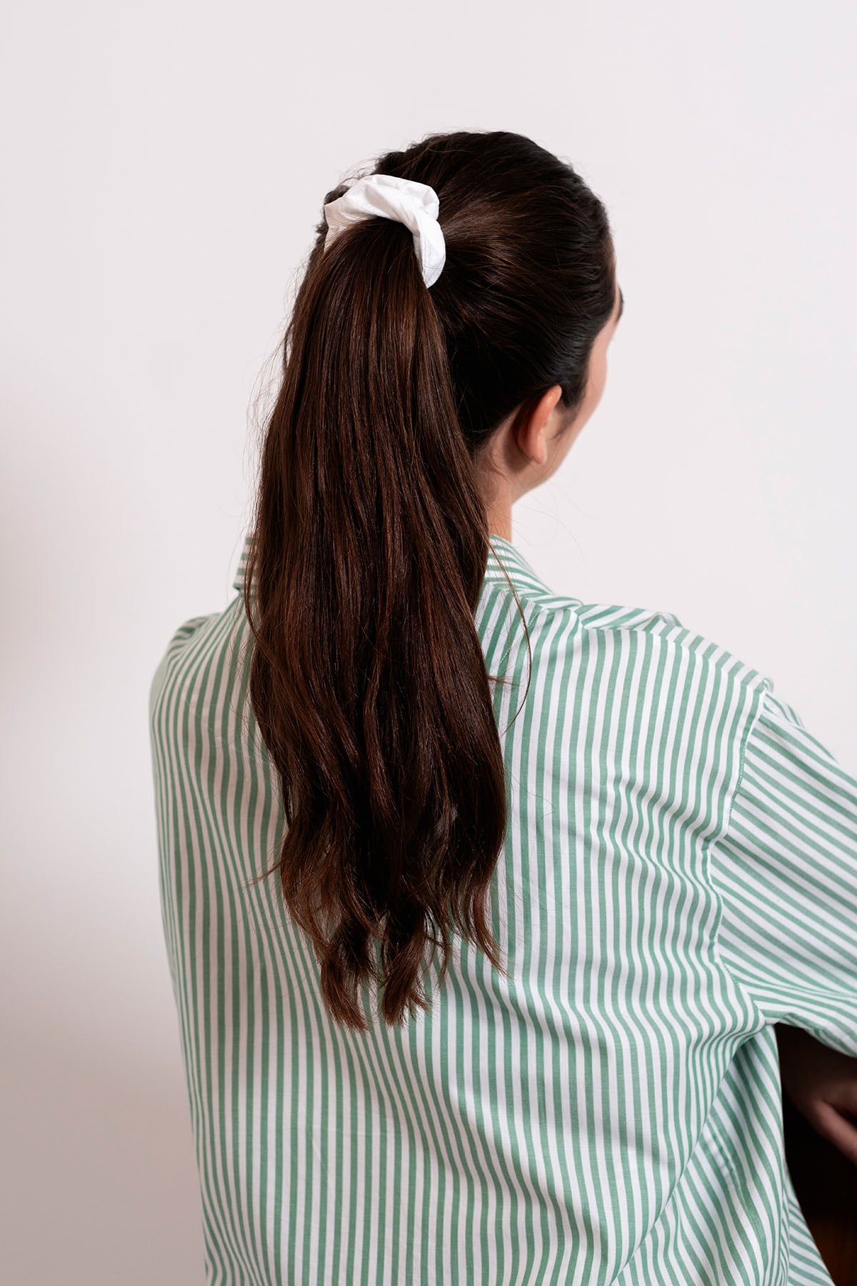 Girl with ponytail and white scrunchie_back view